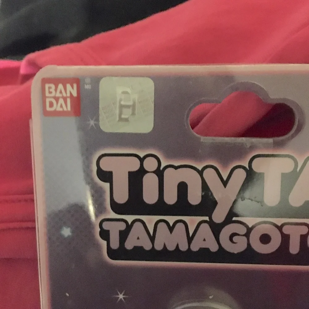 Purple Ban Dai Tiny Tan Tamagotchi.